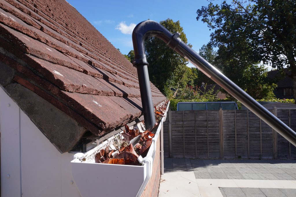 leaves being removed by vacuum system from a gutter